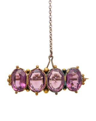 Lot 105 - A Victorian gold paste set brooch, and a rolled gold glazed locket pendant.