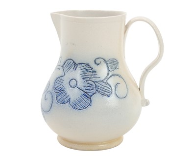 Lot 673 - A good scratch blue decorated English salt-glazed baluster cream jug.