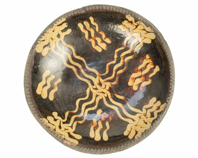 Lot 606 - An English slipware dish.