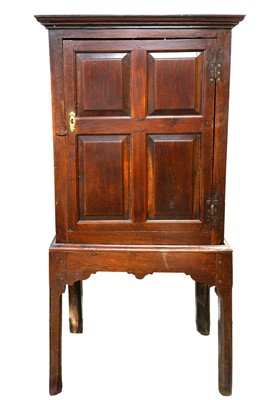 Lot 690 - An 18th century oak cupboard on stand.