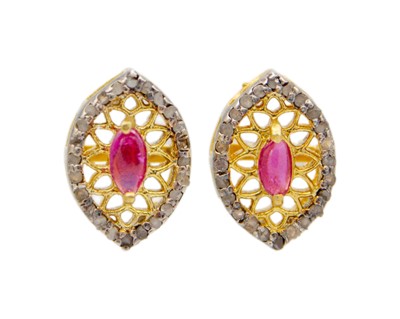 Lot 38 - A pair of silver gilt, ruby, and diamond stud earrings.