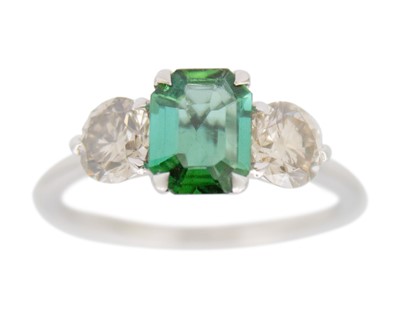 Lot 240 - An attractive green tourmaline and diamond three-stone platinum ring.