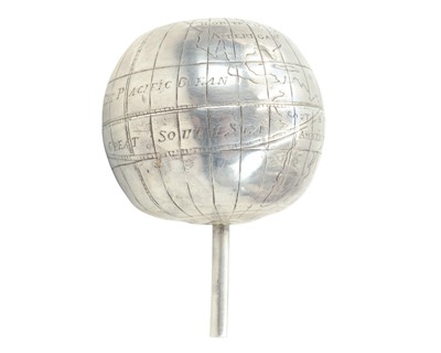 Lot 116 - A miniature white metal terrestrial globe.