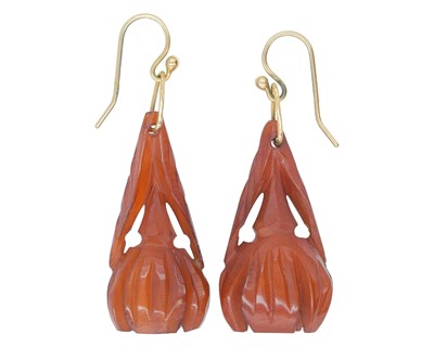 Lot 268 - A pair of carved bakelite pendant earrings fitted on 9k gold hooks.
