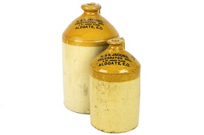 Lot 697 - Two H&S Jacobs 'Celebrated Oil' stoneware flagons.