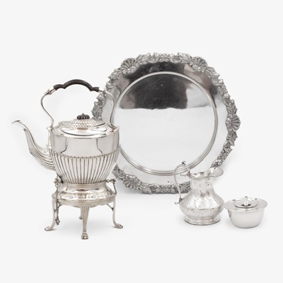 Lot 203 - A selection of three silver-plated wares to include a spirit kettle, a salver and a cream jug.