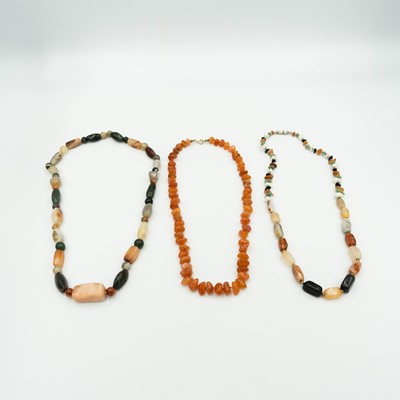 Lot 39 - A Carnelian bead necklace and two hard-stone bead necklaces.