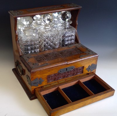 Lot 62 - An Edwardian oak three bottle tantalus with...