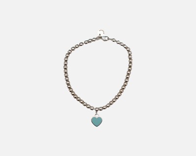 Lot 83 - TIFFANY & CO - A silver bead link bracelet with pouch and original box.