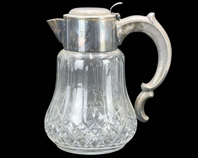 Lot 537 - A cut glass water jug with silver plated mounts and cover.