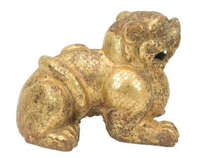 Lot 410 - A Chinese gilt bronze figure of a Buddhist lion or foo dog.