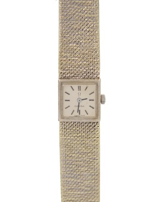 Lot 646 - OMEGA - A 9k white gold lady's manual wind bracelet wristwatch.