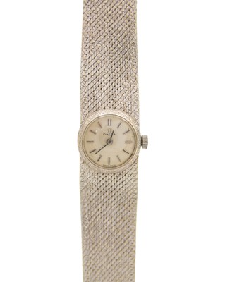 Lot 647 - OMEGA - A 9k white gold manual wind lady's bracelet wristwatch.