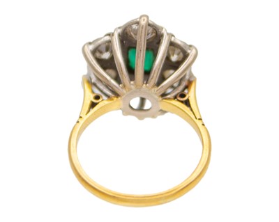 Lot 119 - A good emerald and diamond set 18k and platinum cluster ring.