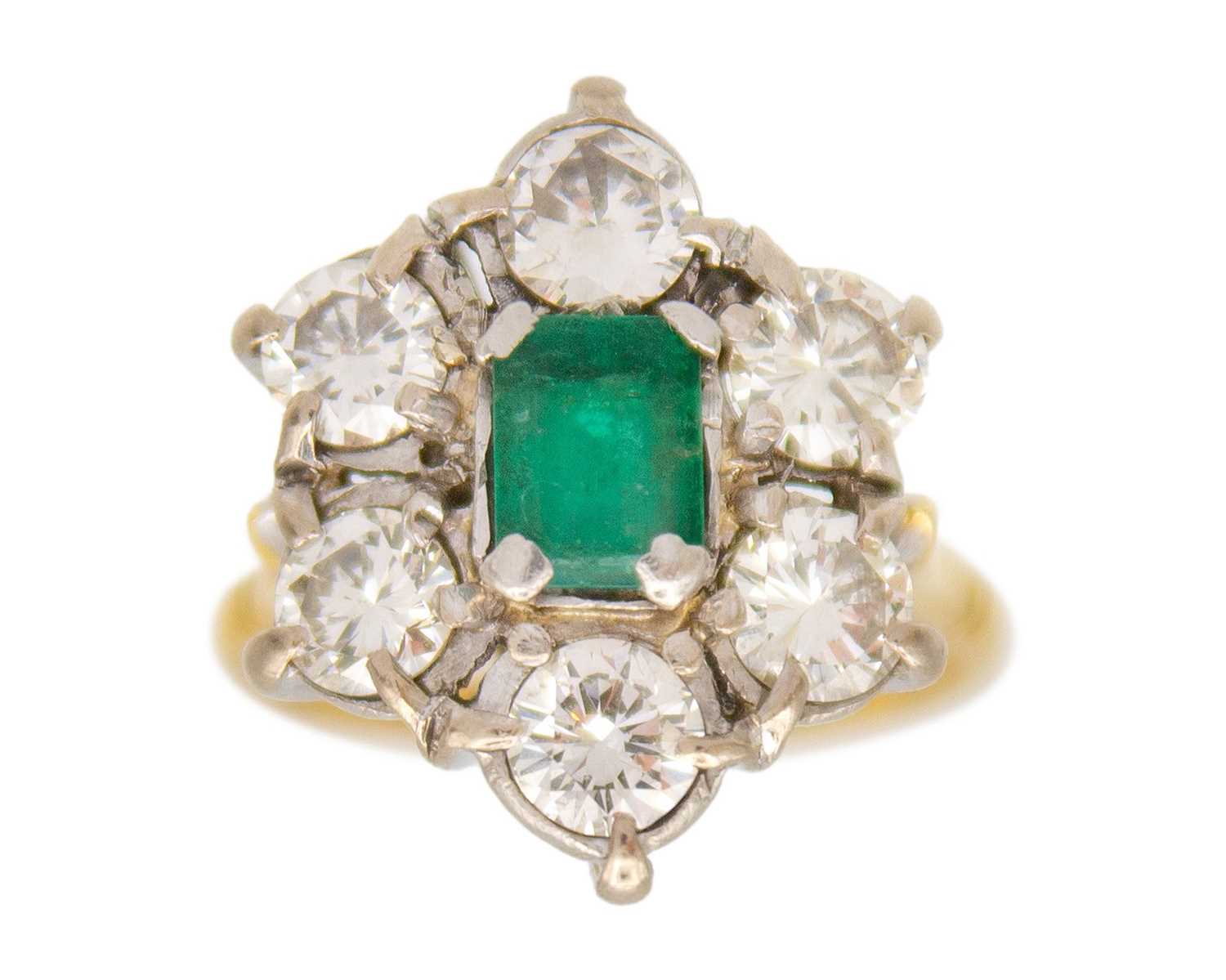 Lot 119 - A good emerald and diamond set 18k and platinum cluster ring.
