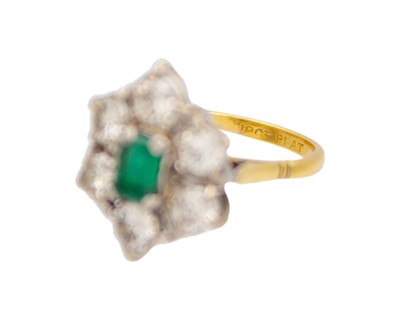 Lot 119 - A good emerald and diamond set 18k and platinum cluster ring.