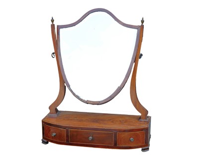 Lot 896 - A late George III mahogany shield shape dressing table mirror.