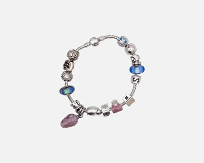 Lot 94 - CHAMILIA - a hallmarked silver charm bracelet in original tin box.