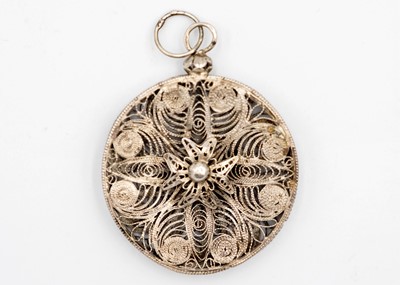 Lot 4 - A silver filigree pendant.