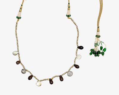 Lot 47 - An Indian necklace set with briolette cut mixed quartz beads, on a metal thread cord with seed pearl tassel.
