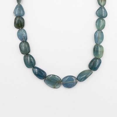 Lot 74 - An apatite irregular bead necklace, strung to a silver diamond set lobster clasp.