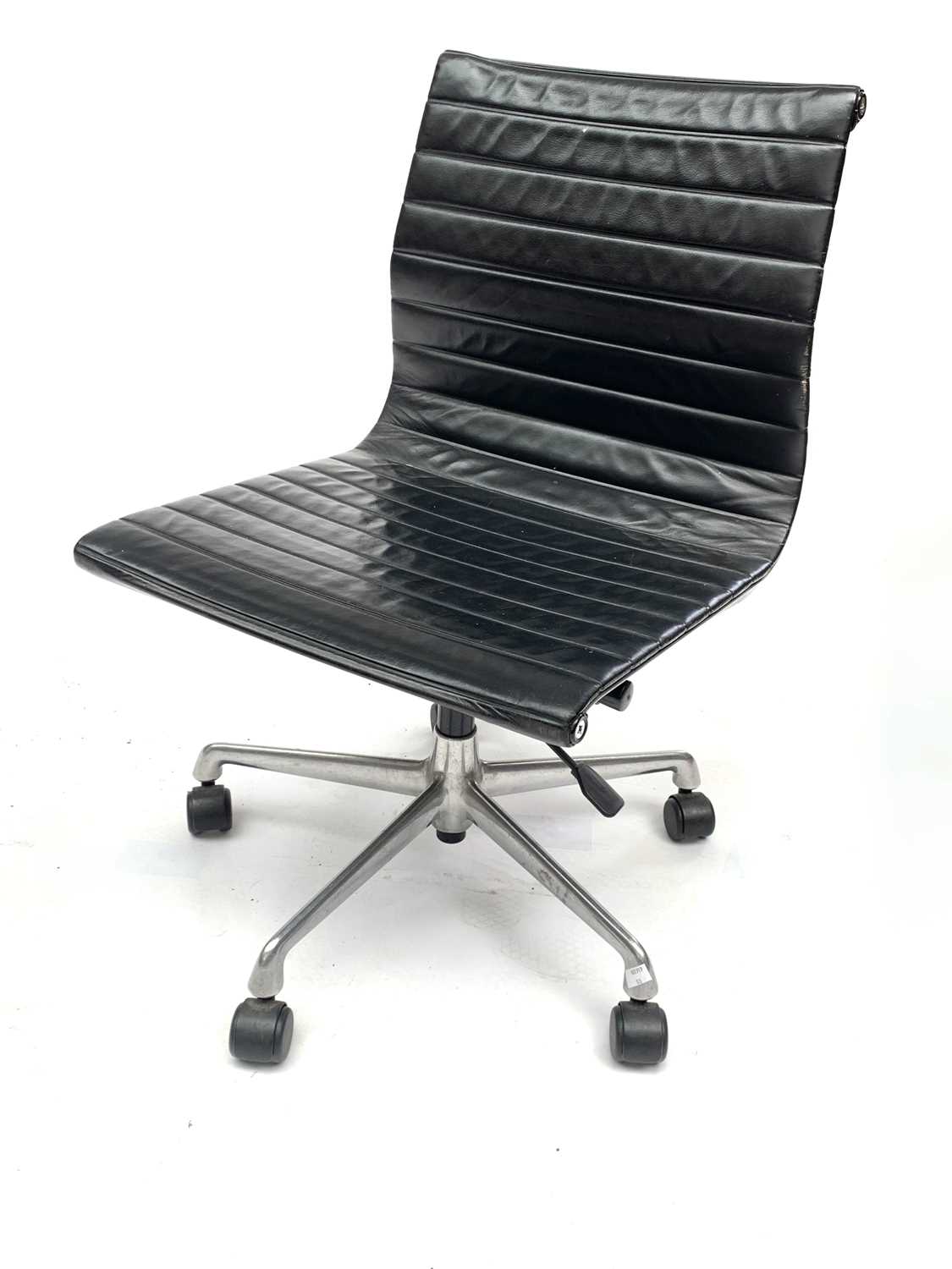 Lot 3076 - A Charles Eames black leather EA105 swivel...