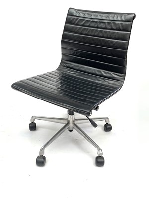 Lot 3076 - A Charles Eames black leather EA105 swivel...