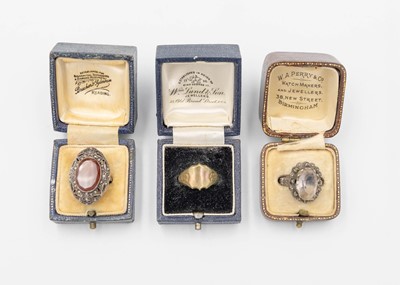 Lot 13 - An Arts & Crafts rose quartz set silver ring, a carnelian set silver ring and a base signet ring.