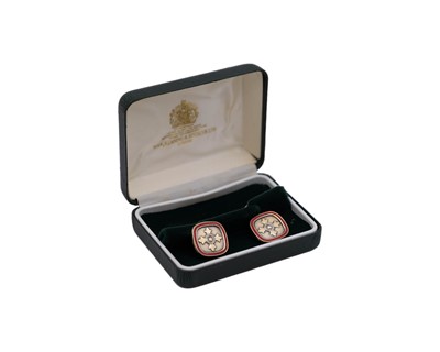 Lot 41 - A pair of sterling silver-gilt red enamel OBE cufflinks, by Toye, Kenning & Spencer Ltd.