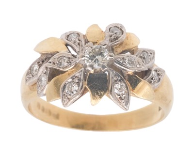 Lot 18 - A Modernist 18k white and yellow gold diamond set flower head design ring.