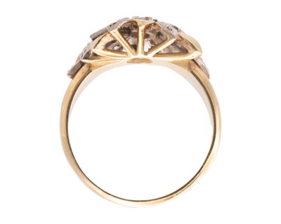 Lot 18 - A Modernist 18k white and yellow gold diamond set flower head design ring.