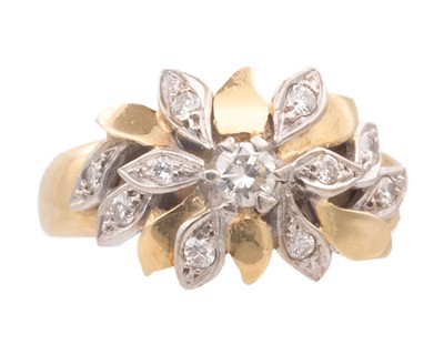 Lot 18 - A Modernist 18k white and yellow gold diamond set flower head design ring.