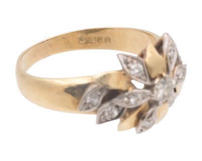 Lot 18 - A Modernist 18k white and yellow gold diamond set flower head design ring.