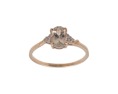 Lot 33 - A 9k diamond and oval Csarite ( Diaspore) set ring by Gemporia.