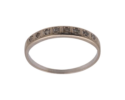 Lot 35 - A high-purity white gold diamond set half eternity ring.