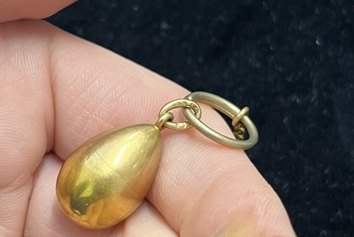 Lot 1 - An Imperial Russia gold egg locket pendant, on a gold split ring and gold chain.