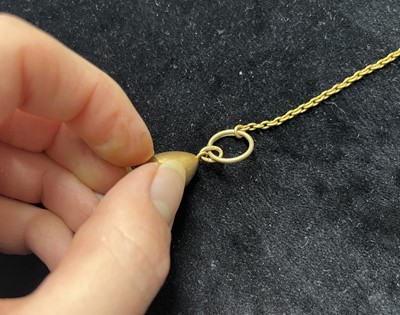 Lot 1 - An Imperial Russia gold egg locket pendant, on a gold split ring and gold chain.
