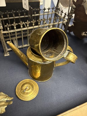 Lot 22 - A brass plate warmer, of pierced circular form, with swing handle.