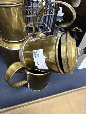 Lot 22 - A brass plate warmer, of pierced circular form, with swing handle.