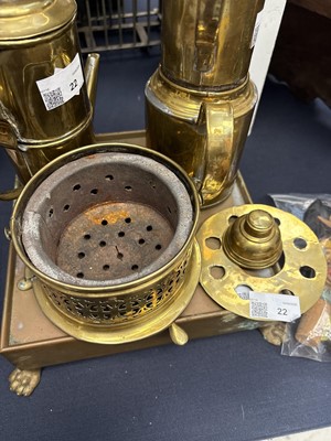Lot 22 - A brass plate warmer, of pierced circular form, with swing handle.