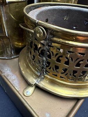 Lot 22 - A brass plate warmer, of pierced circular form, with swing handle.