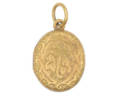 Lot 2 - A Victorian gold oval locket with foliate engraved decoration.