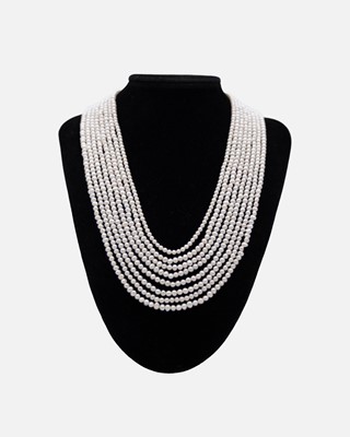 Lot 27 - An eight strand white cultured pearl necklace, strung to white base metal CZ set bars and hook clasp.