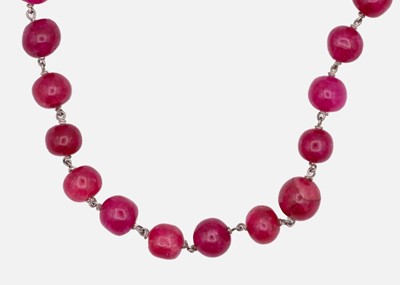 Lot 23 - A red dyed quartz long circular bead necklace.