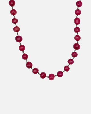 Lot 51 - A red dyed quartz long circular bead necklace.
