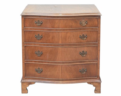 Lot 904 - A mahogany serpentine front chest of four long drawers.