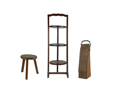 Lot 699 - A mid-century ebonised and stained mahogany three tier cake stand.