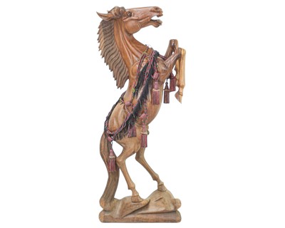 Lot 102 - A large carved hardwood figure of a rearing stallion.