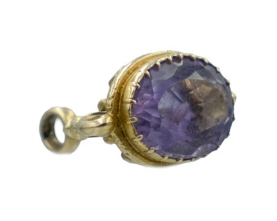 Lot 559 - A 9k hallmarked gold and amethyst set fob.