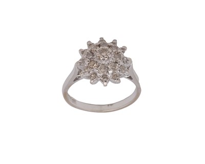 Lot 87 - An 18k hallmarked white gold diamond set cluster ring.